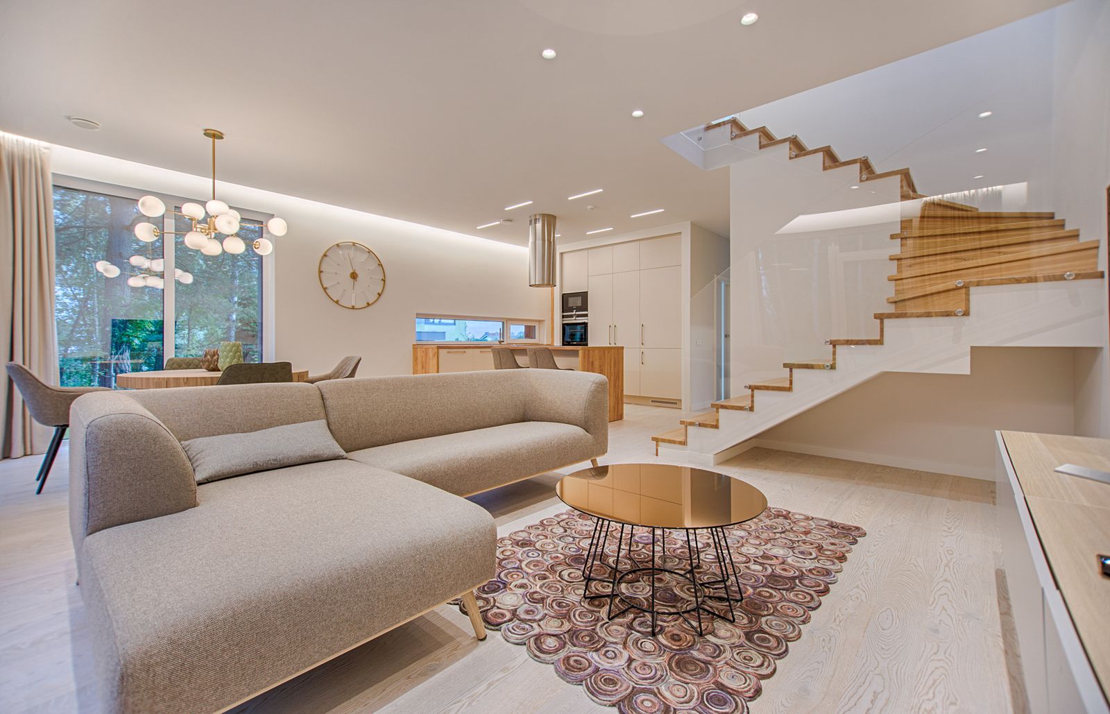Modern open-plan interior with a warm neutral palette and refined wall finishes