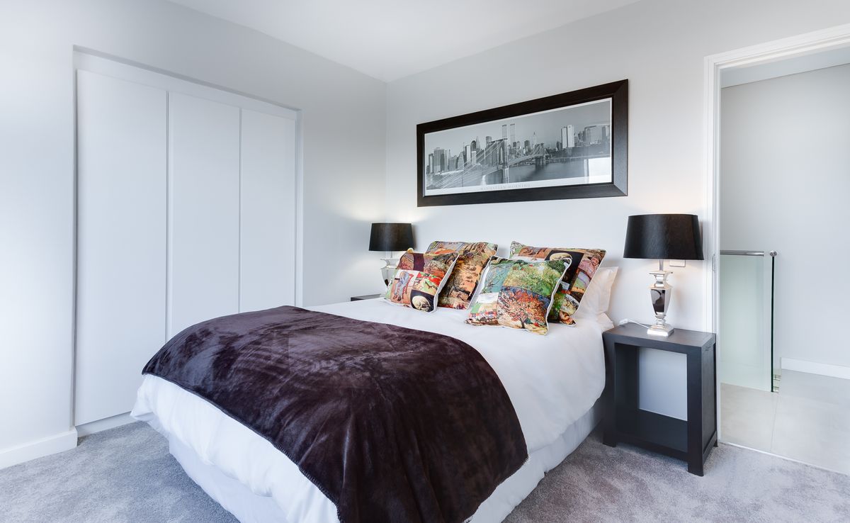 Calm bedroom interior with a tailored wall finish and soft styling