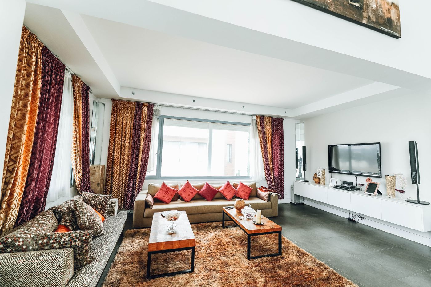 Designer interior with richly patterned drapery and a layered, upscale finish